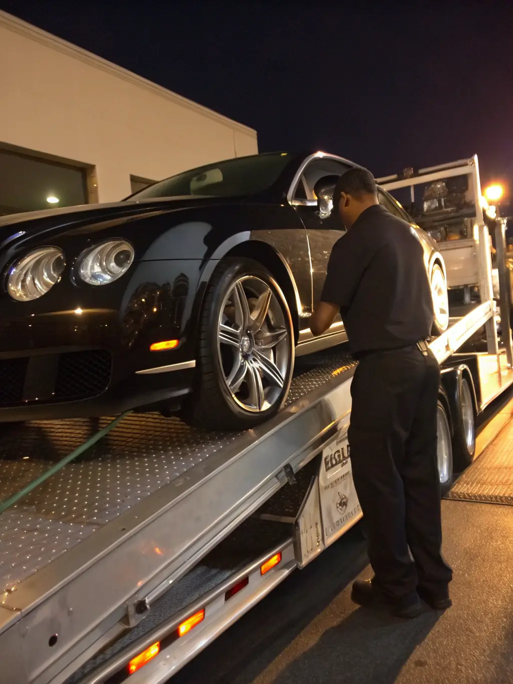A photograph of a luxury car being loaded onto a transport carrier, symbolizing the seamless import/export services offered by Global Drive Motors.